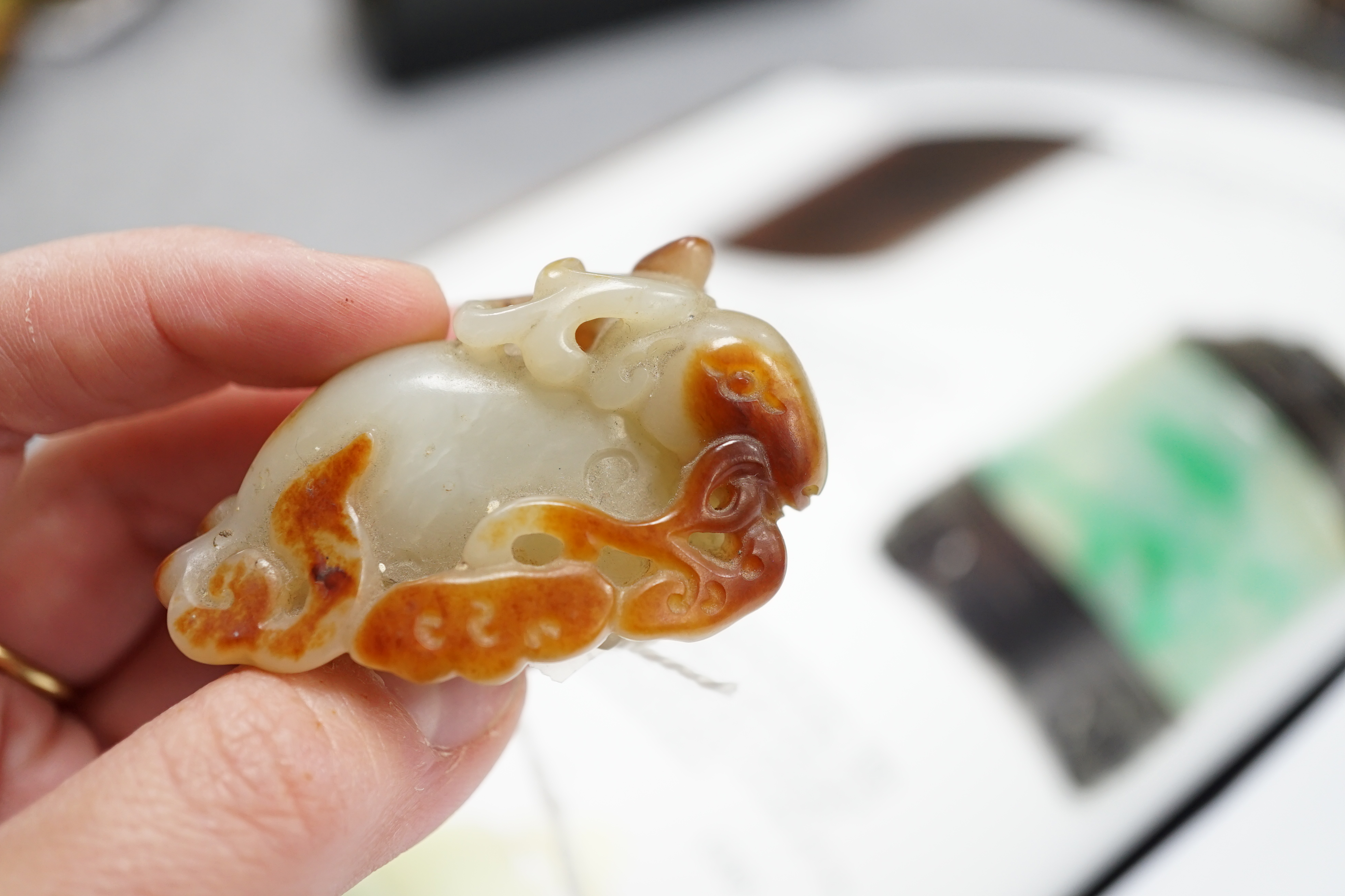 A Chinese pale celadon and russet skin jade figure of a stag, 19th century
